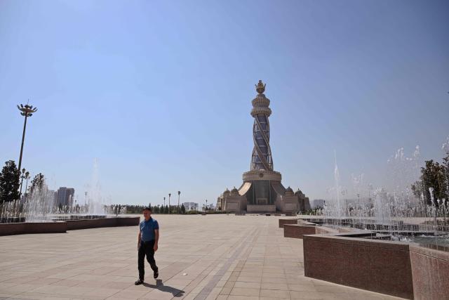 A man walks by the Istiklol (indenpendence) Monument park at the Tajikistan capital, Dushanbe on September 12, 2025 (Photo by PRAKASH MATHEMA / AFP)