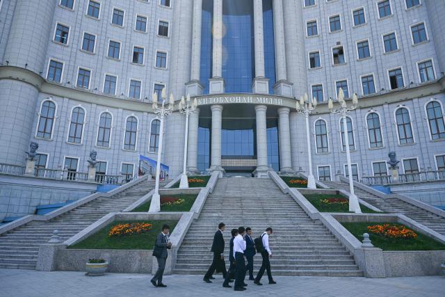 A group of students walks past Tajikistan's National Library building, in Dushanbe on September 12, 2025. (Photo by PRAKASH MATHEMA / AFP)