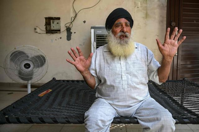 In this photograph taken on September 12, 2025, Balkar Singh, a farmer, speaks during an interview with AFP in the village of Shehzada on the outskirts of Amritsar in India's Punjab state. The fields are full but the paddy brown and wilted, and the air thick with the stench of rotting crops and livestock -- the aftermath of record monsoon rains that have devastated India's breadbasket. (Photo by Narinder NANU / AFP) / To go with 'India-Pakistan-Flood-Climate-Agriculture', FOCUS by Arunabh SAIKIA