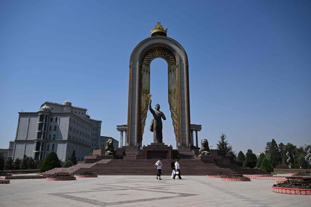 Pedestrians walk past the Monument of Ismoil Somoni on the Ozodi square in Dushanbe, Tajikistan's capital on September 12, 2025. (Photo by PRAKASH MATHEMA / AFP)