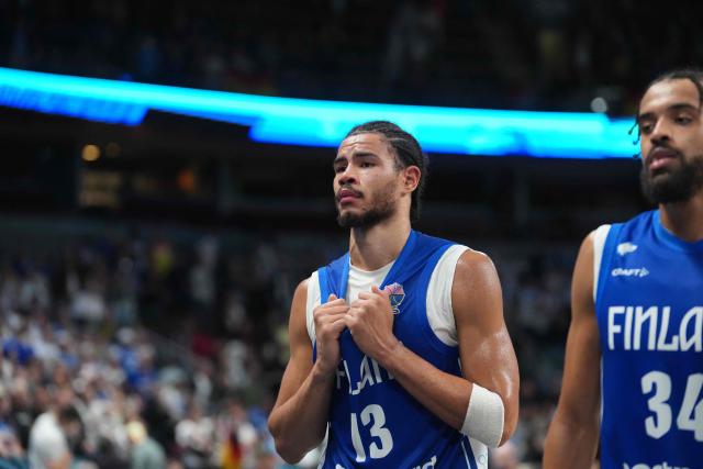 Finland's power forward #13 Olivier Nkamhoua (L) and Finland's shooting guard #34 Jacob Grandison react after the end of the FIBA EuroBasket 2025 semi-final basketball match between Germany and Finland in Riga, Latvia, on September 12, 2025. (Photo by Gints Ivuskans / AFP)