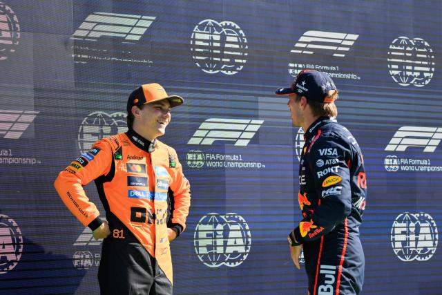McLaren's Australian driver Oscar Piastri (L) speaks with third-placed Red Bull Racing's Dutch driver Max Verstappen after winning the pole position during the qualifying session of the Formula One Dutch Grand Prix at The Circuit Zandvoort, western Netherlands, on August 30, 2025. (Photo by JOHN THYS / AFP)