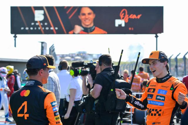 McLaren's Australian driver Oscar Piastri (R) speaks with second-placed McLaren's British driver Lando Norris after winning the pole position during the qualifying session of the Formula One Dutch Grand Prix at The Circuit Zandvoort, western Netherlands, on August 30, 2025. (Photo by JOHN THYS / AFP)