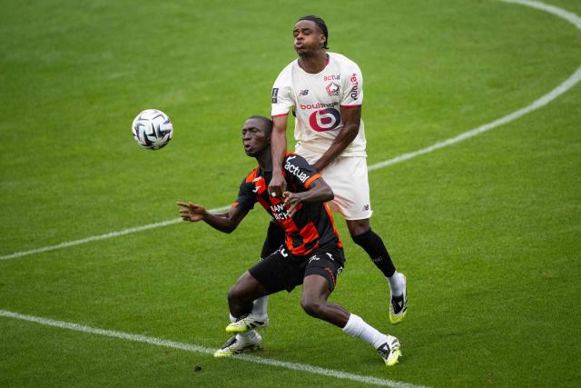 Lorient's Senegalese forward #28 Sambou Soumano (C) fights for the ball with Lille's Belgian defender #03 Nathan Ngoy (R) during the French L1 football match between FC Lorient and lille OSC at Yves-Allainmat stadium in Lorient, western France on August 30, 2025. (Photo by Loic VENANCE / AFP)