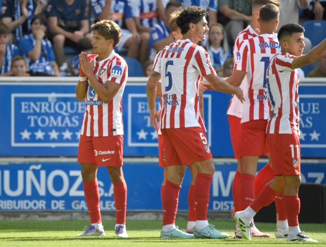 Atletico Madrid's Argentine forward #20 Giuliano Simeone (L) celebrates scoring his team's first goal during the Spanish league football match between Deportivo Alaves and Club Atletico de Madrid at the Mendizorroza stadium in Vitoria on August 30, 2025. (Photo by ANDER GILLENEA / AFP)