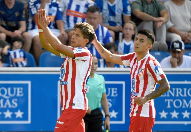 Atletico Madrid's Argentine forward #20 Giuliano Simeone (L) celebrates with Atletico Madrid's Argentine midfielder #11 Thiago Almada scoring his team's first goal during the Spanish league football match between Deportivo Alaves and Club Atletico de Madrid at the Mendizorroza stadium in Vitoria on August 30, 2025. (Photo by ANDER GILLENEA / AFP)