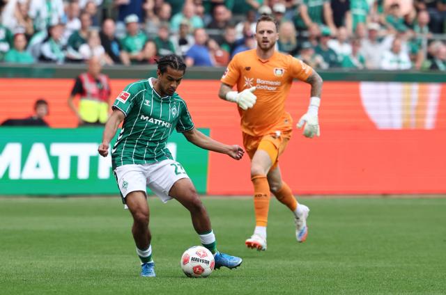 Bremen's Swiss defender #22 Isaac Schmidt (L) scores during the German first division Bundesliga football match between Werder Bremen and Bayer Leverkusen in Bremen on August 30, 2025. (Photo by Ibrahim OT / AFP) / DFL REGULATIONS PROHIBIT ANY USE OF PHOTOGRAPHS AS IMAGE SEQUENCES AND/OR QUASI-VIDEO