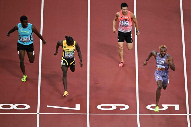 Bahamas' athlete Terrence Jones (L), Japan's Yoshihide Kiryu and US sprinter Noah Lyles compete in the men's 100m heats during the World Athletics Championships in Tokyo on September 13, 2025. (Photo by Philip FONG / AFP)