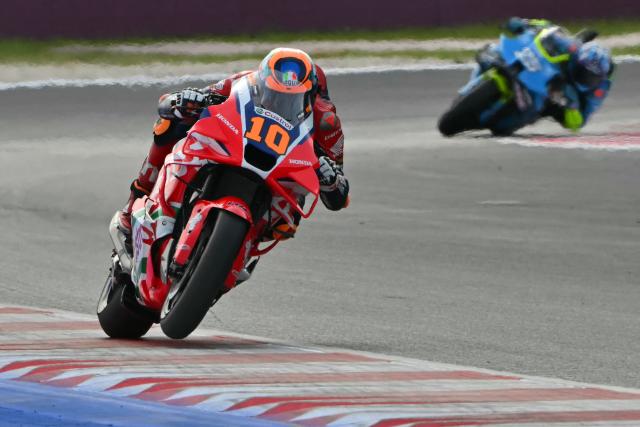 Honda HRC Castrol team's Italian MotoGP rider Luca Marini (L) accelerates during the San Marino Moto GP Sprint Race at the Misano World Circuit Marco Simoncelli, in Misano Adriatico, northern Italy, on September 13, 2025. (Photo by Andreas SOLARO / AFP)