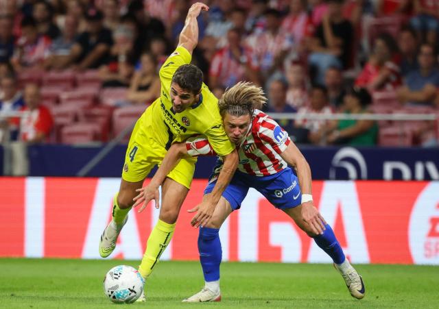 Atletico Madrid's English midfielder #04 Conor Gallagher (R) vies for the ball with Villarreal's Spanish midfielder #14 Santi Comesana during the Spanish league football match between Club Atletico de Madrid and Villarreal CF at the Metropolitano Stadium in Madrid on September 13, 2025. (Photo by Thomas COEX / AFP)