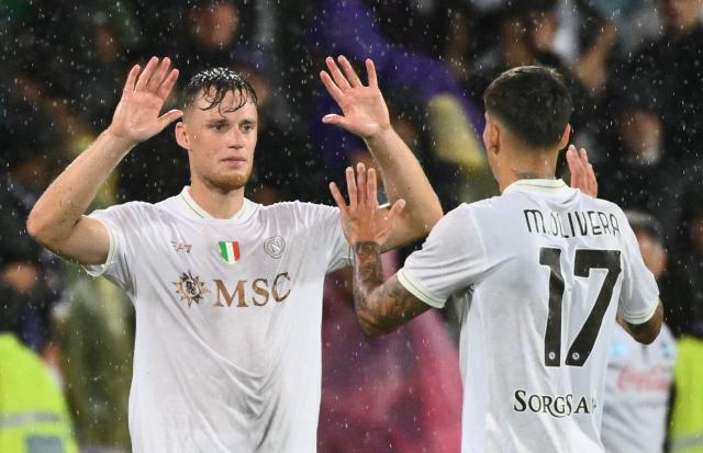 Napoli's Dutch defender #31 Sam Beukema (L) and Napoli's Uruguayan defender #17 Mathias Olivera celebrate at the end of the Italian Serie A football match between ACF Fiorentina and Napoli at Artemio Franchi stadium, in Florence, on September 13, 2025. Napoli wins 3-1 against Fiorentina. (Photo by Alberto PIZZOLI / AFP)