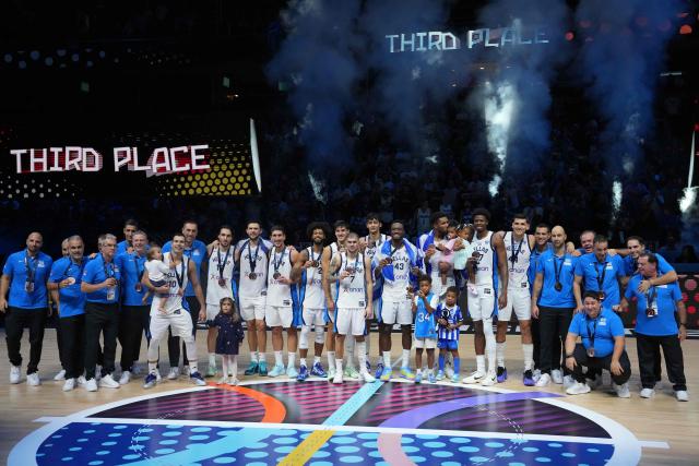 Greece's team celebrates after winning third place in the FIBA EuroBasket 2025 small final basketball match between Greece and Finland in Riga, Latvia, on September 14, 2025. (Photo by Gints Ivuskans / AFP)