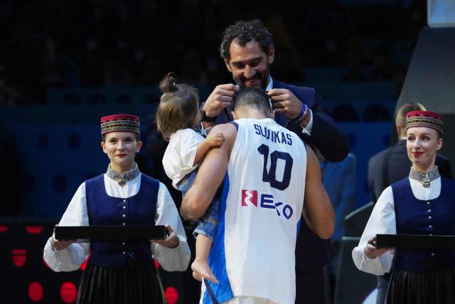 Greece's guard #10 Kostas Sloukas receives his bronze medal from President of FIBA Europe Jorge Garbajosa (C,top) after winning third place in the FIBA EuroBasket 2025 small final basketball match between Greece and Finland in Riga, Latvia, on September 14, 2025. (Photo by Gints Ivuskans / AFP)