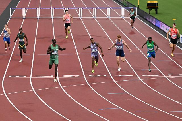 Athletes including Nigeria's athlete Ezekiel Nathaniel, US' athlete Caleb Dean and Britain's athlete Alastair Chalmers cross the finish line in the men's 400m hurdles heats during the World Athletics Championships in Tokyo on September 15, 2025. (Photo by Jewel SAMAD / AFP)