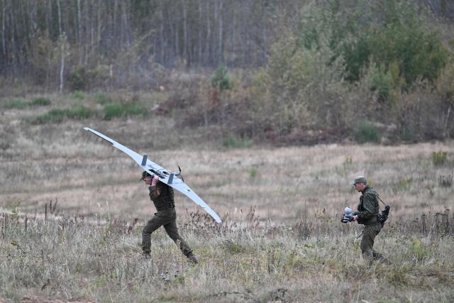 A Belarus' serviceman carries an unmanned aerial vehicle (UAV) during the "Zapad-2025" (West-2025) joint Russian-Belarusian military drills at a training ground near the town of Borisov, east of the capital Minsk, on September 15, 2025. (Photo by Olesya KURPYAYEVA / AFP)