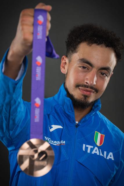 Bronze medallist in the men's marathon Italy's athlete Iliass Aouani poses with his medal pose with his medal during a studio photo session on the sidelines of the World Athletics Championships in Tokyo on September 15, 2025. (Photo by Andrej ISAKOVIC / AFP)