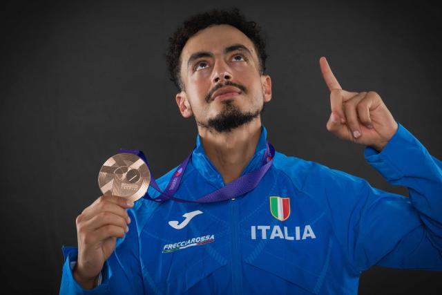 Bronze medallist in the men's marathon Italy's athlete Iliass Aouani poses with his medal pose with his medal during a studio photo session on the sidelines of the World Athletics Championships in Tokyo on September 15, 2025. (Photo by Andrej ISAKOVIC / AFP)