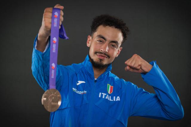 Bronze medallist in the men's marathon Italy's athlete Iliass Aouani poses with his medal pose with his medal during a studio photo session on the sidelines of the World Athletics Championships in Tokyo on September 15, 2025. (Photo by Andrej ISAKOVIC / AFP)