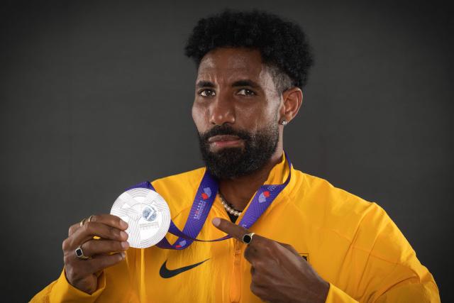 Silver medallist in the men's marathon Germany's Amanal Petros poses with his medal during a studio photo session on the sidelines of the World Athletics Championships in Tokyo on September 15, 2025. (Photo by Andrej ISAKOVIC / AFP)