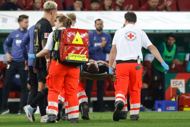 Augsburg's German midfielder #19 Robin Fellhauer is stretchered off following a clash of heads during the German first division Bundesliga football match between FC Augsburg and FC Bayern Munich in Augsburg, southern Germany, on August 30, 2025. (Photo by Michaela STACHE / AFP) / DFL REGULATIONS PROHIBIT ANY USE OF PHOTOGRAPHS AS IMAGE SEQUENCES AND/OR QUASI-VIDEO