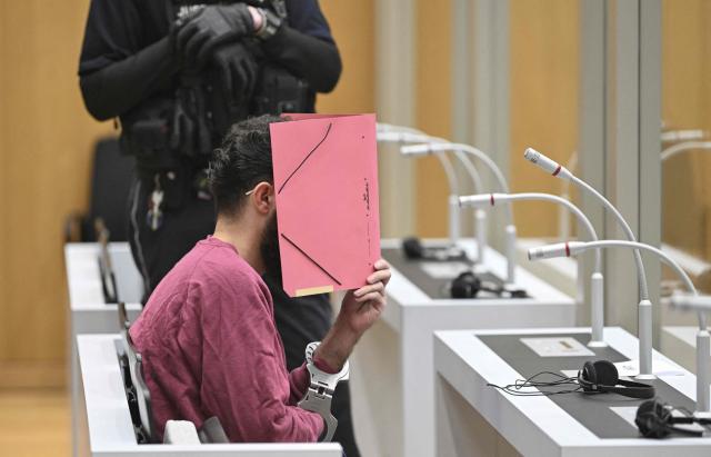(FILES) The defendant sits in the courtroom of the Higher Regional Court in Stuttgart-Stammheim, southern Germany, on February 13, 2025, before the start of his trial for murdering a police officer and attempting to murder five others at the market square in Mannheim on May 31, 2024. On September 16, 2025, the verdict is expected in the trial of an Afghan man accused of a deadly jihadist stabbing, during which a police officer was killed, and for attempting to murder five others at the market square in Mannheim, southwestern Germany on May 31, 2024. (Photo by THOMAS KIENZLE / POOL / AFP)