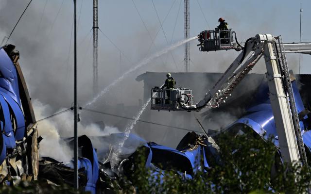 Ukrainian rescuers work to extinguish a fire at the site of a drone attack at an undisclosed location in Fastiv district in the Kyiv region on September 16, 2025, amid the Russian invasion of Ukraine. (Photo by Genya SAVILOV / AFP)