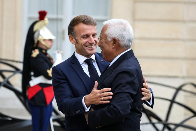 France's President Emmanuel Macron (L) welcomes European Council President Antonio Costa (R) upon his arrival ahead of a meeting at the presidential Elysee Palace, in Paris, on September 16, 2025. (Photo by Alain JOCARD / AFP)