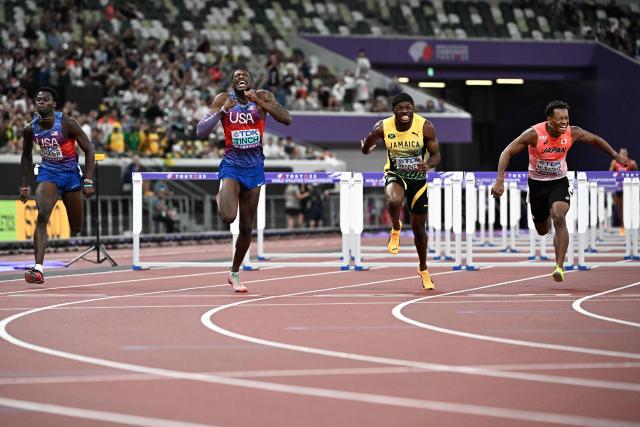 (L-R) US' athlete Ja'Kobe Tharp, US' athlete Cordell Tinch, Jamaica's Orlando Bennett and Japan's athlete Rachid Muratake cross the finish line in the men's 110m hurdles final during the World Athletics Championships in Tokyo on September 16, 2025. (Photo by Jewel SAMAD / AFP)