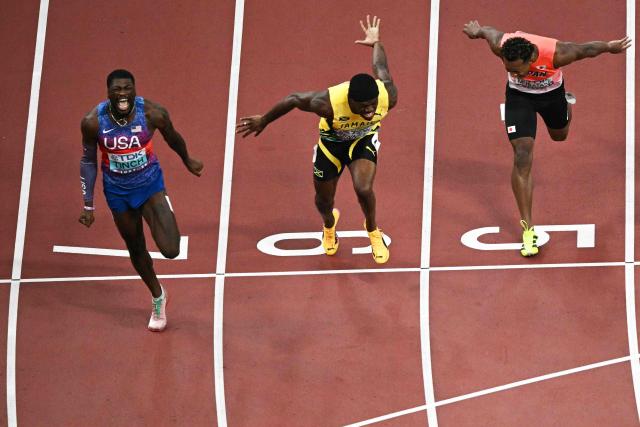 US' athlete Cordell Tinch, Jamaica's athlete Orlando Bennett and Japan's athlete Rachid Muratake cross the finish line in the men's 110m hurdles final during the World Athletics Championships in Tokyo on September 16, 2025. (Photo by Philip FONG / AFP)