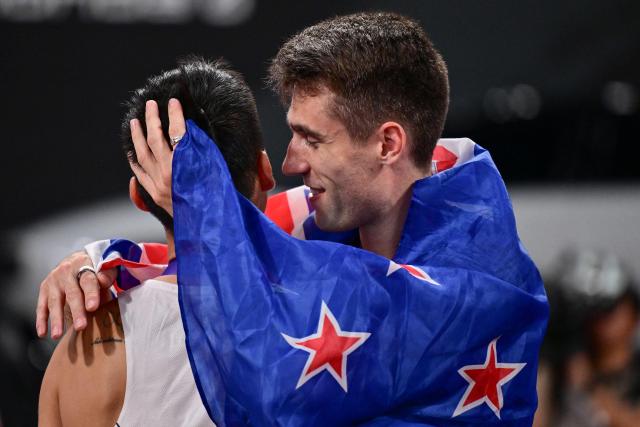 Gold medallist New Zealand's athlete Hamish Kerr (R) and silver medallist South Korea's Sanghyeok Woo celebrate after the men's high jump final during the World Athletics Championships in Tokyo on September 16, 2025. (Photo by Ben STANSALL / AFP)