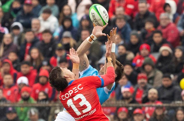 Chile's centre #13 Matias Garafulic and Uruguay's centre #12 Andres Vilaseca fight for the ball during the Rugby World Cup qualifiying 2025 first leg final between Chile and Uruguay at the La Pintana Municipal stadium in Santiago, on August 30, 2025. (Photo by Raul BRAVO / AFP)
