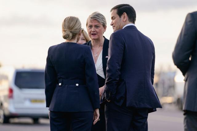 US Secretary of State Marco Rubio (R) is greeted by Britain's Foreign Secretary Yvette Cooper (C) as he disembarks from an aircraft after landing at Stansted Airport, eastern England, on September 16, 2025. US President Donald Trump will arrive in the UK late Tuesday for a second State Visit with his wife, Melania -- a rare privilege made at the invitation of King Charles III. (Photo by Nathan Howard / POOL / AFP)
