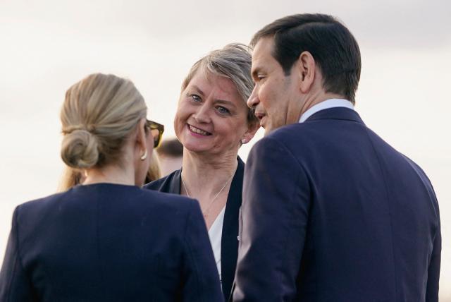 US Secretary of State Marco Rubio (R) is greeted by Britain's Foreign Secretary Yvette Cooper (C) as he disembarks from an aircraft after landing at Stansted Airport, eastern England, on September 16, 2025. US President Donald Trump will arrive in the UK late Tuesday for a second State Visit with his wife, Melania -- a rare privilege made at the invitation of King Charles III. (Photo by Nathan Howard / POOL / AFP)