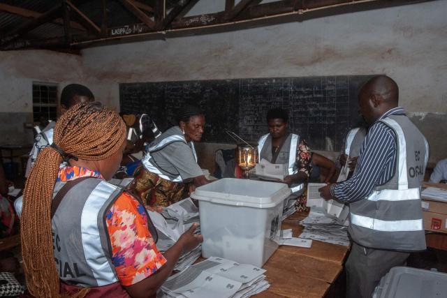 Election officials count votes at the end of polling for the presidential and parliamentary elections, in Lilongwe on September 16, 2025. (Photo by Amos GUMULIRA / AFP)