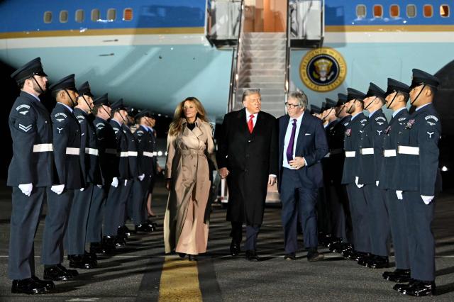 US President Donald Trump (C) and US First Lady Melania Trump disembark from Air Force One after landing at Stansted Airport, eastern England, on September 16, 2025, on the first day of a two-day visit to the UK. US President Donald Trump arrived in the UK late Tuesday for a State Visit with his wife, Melania, a rare privilege made at the invitation of King Charles III. (Photo by ANDREW CABALLERO-REYNOLDS / AFP)