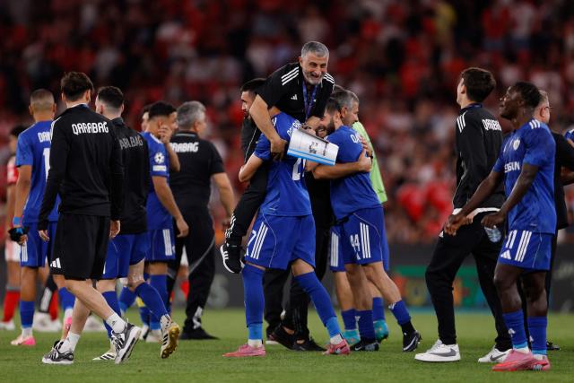TOPSHOT - Garabagh players and coaching staff celebrate after winning the UEFA Champions League first round day 1 football match between SL Benfica and Garabagh at the Luz stadium in Lisbon on September 16, 2025. (Photo by FILIPE AMORIM / AFP)
