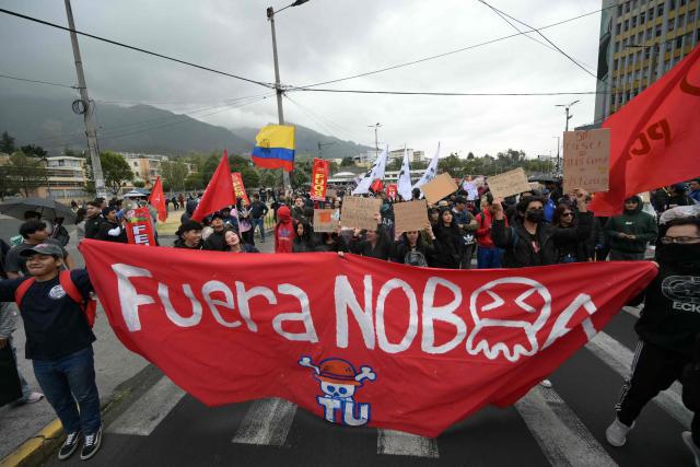 University students hold a sign reading "Noboa out" during a protest against president Daniel Noboa cuts and the elimination of diesel subsidy within a state of emergency declared by the government, in Quito on September 16, 2025. (Photo by Rodrigo BUENDIA / AFP)