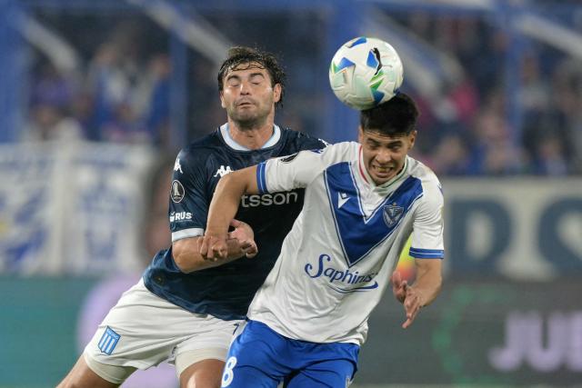 Racing's midfielder #13 Santiago Sosa and Velez Sarsfield's midfielder #08 Tomas Galvan fight for the ball during the Copa Libertadores quarterfinal first leg all-Argentine football match between Velez Sarsfield and Racing at the Jose Amalfitani Stadium in Buenos Aires on September 16, 2025. (Photo by JUAN MABROMATA / AFP)