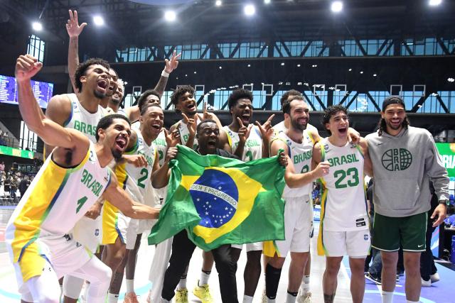 Brazil's players celebrate after winning the FIBA Men's Americup 2025 semifinal basketball match between US and Brazil at the Polideportivo Alexis Arguello Stadium in Managua on August 30, 2025. (Photo by AFP)