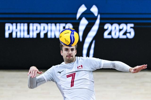 Canada's Jackson Howe attempts to spike the ball against Turkey during the 2025 Men's Volleyball World Championship at Araneta Coliseum in Quezon City, metro Manila on September 17, 2025. (Photo by SHERWIN VARDELEON / AFP)