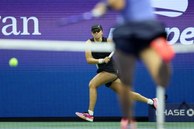 Poland's Iga Swiatek (L) plays a forehand return to Russia's Anna Kalinskaya during their women's singles third round match against on day seven of the US Open tennis tournament at the USTA Billie Jean King National Tennis Center in New York City, on August 30, 2025. (Photo by CHARLY TRIBALLEAU / AFP)