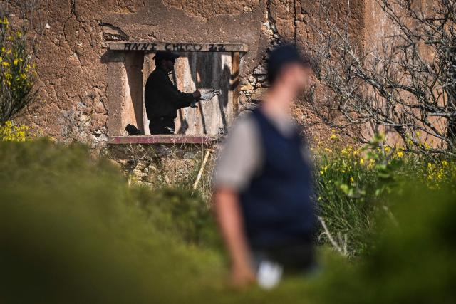(FILES) Police investigators work near an abandoned house during  new search operations amid the investigation into the disappearance of Madeleine (or Maddie) McCann at Atalaia, Lagos in Algarve on June 4, 2025. Christian B is accused of three counts of rape and two counts of child sex abuse allegedly committed in Portugal between 2000 and 2017. The charges are unrelated to the Madeleine McCann case, in which Christian B was sensationally revealed as a suspect in 2020. The man is already behind bars in Germany for raping a 72-year-old American tourist in 2005 in Praia da Luz, the same Portuguese seaside resort where Madeleine McCann, often referred to as Maddie, went missing two years later. (Photo by Patricia DE MELO MOREIRA / AFP)