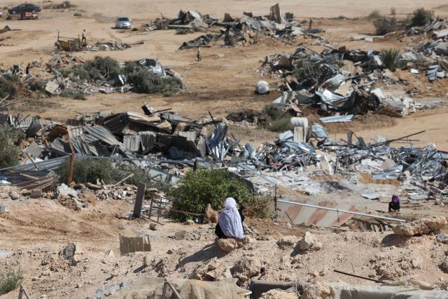 Bedouin residents look at housing structures demolished by Israeli forces in the unrecognized village of as-Sir in the Negev desert in southern Israel on September 17, 2025. Israeli media said Bedouins protestered on September 17 against the demolition of tens of Arab residential structures deemed illegally built by the Israeli land authority in the northern Negev, south of Beersheva. (Photo by Ahmad GHARABLI / AFP)