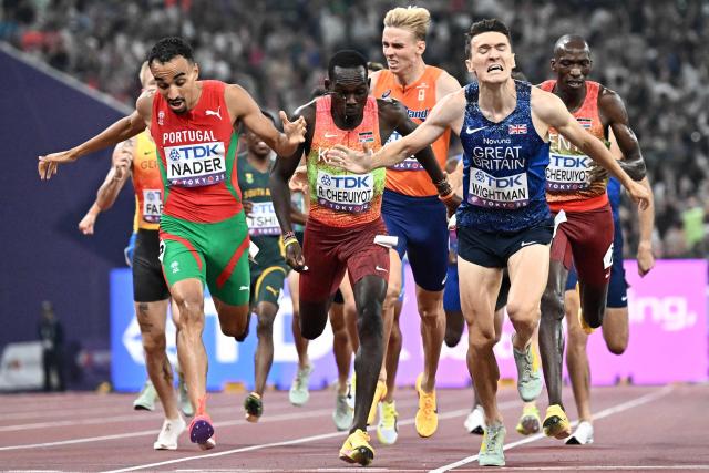 Portugal's Isaac Nader (L), Kenya's Reynold Cheruiyot and Britain's athlete Jake Wightman  run to cross the finish line in the men's 1500m final during the World Athletics Championships in Tokyo on September 17, 2025. (Photo by Jewel SAMAD / AFP)