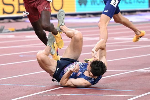 Britain's athlete Jake Wightman crashes as he crosses the finish line to win second place in the men's 1500m final during the World Athletics Championships in Tokyo on September 17, 2025. (Photo by Kirill KUDRYAVTSEV / AFP)