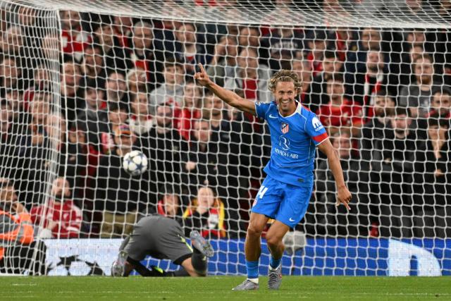 Atletico Madrid's Spanish midfielder #14 Marcos Llorente celebrates scoring his team's first goal during the UEFA Champions League first round football match between Liverpool and Atletico Madrid at Anfield in Liverpool, north west England on September 17, 2025. (Photo by Oli SCARFF / AFP)