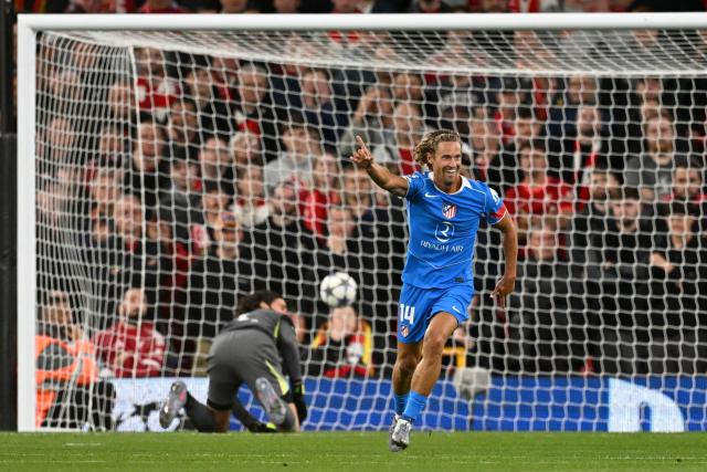 Atletico Madrid's Spanish midfielder #14 Marcos Llorente celebrates scoring his team's first goal during the UEFA Champions League first round football match between Liverpool and Atletico Madrid at Anfield in Liverpool, north west England on September 17, 2025. (Photo by Oli SCARFF / AFP)