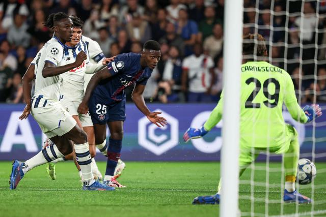 Paris Saint-Germain's Portuguese defender #25 Nuno Mendes (C) scores PSG's third goal during the UEFA Champions League first round day 1 football match between Paris Saint-Germain (FRA) and Atalanta (ITA) at the Parc des Princes stadium in Paris on September 17, 2025. (Photo by Anne-Christine POUJOULAT / AFP)