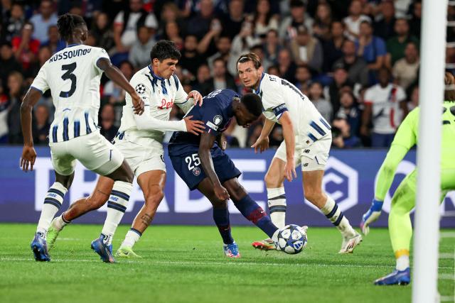 Paris Saint-Germain's Portuguese defender #25 Nuno Mendes (C) shoots to score PSG's third goal during the UEFA Champions League first round day 1 football match between Paris Saint-Germain (FRA) and Atalanta (ITA) at the Parc des Princes stadium in Paris on September 17, 2025. (Photo by Anne-Christine POUJOULAT / AFP)