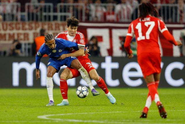 Chelsea's Brazilian forward #20 Joao Pedro (L) and Bayern Munich's South Korean defender #03 Kim Min-Jae (C) vie for the ball during the UEFA Champions League football match between FC Bayern Munich and Chelsea FC in Munich, southern Germany on September 17, 2025. (Photo by Alexandra BEIER / AFP)